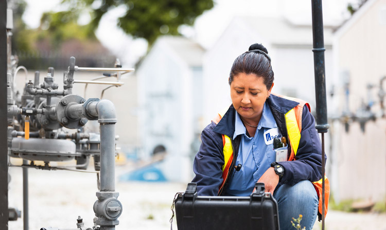 woman employee working on meter