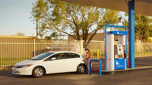 woman refueling car
