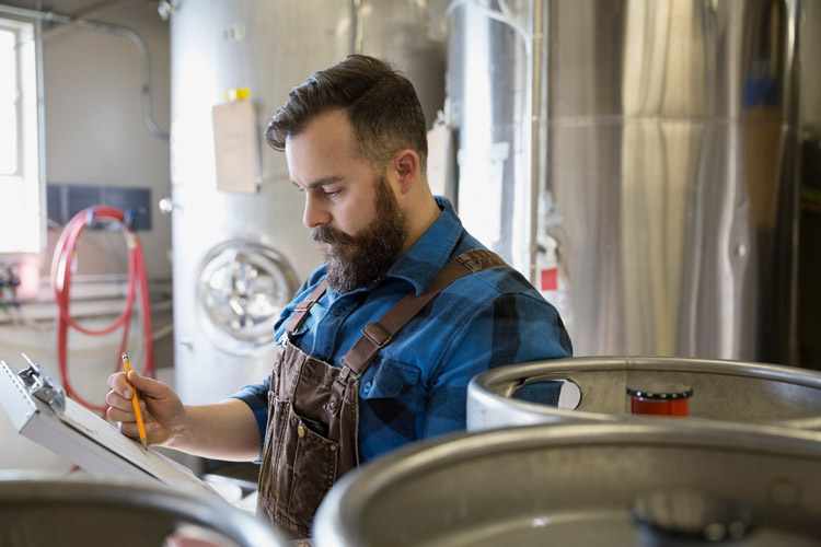 man with overalls and clipboard
