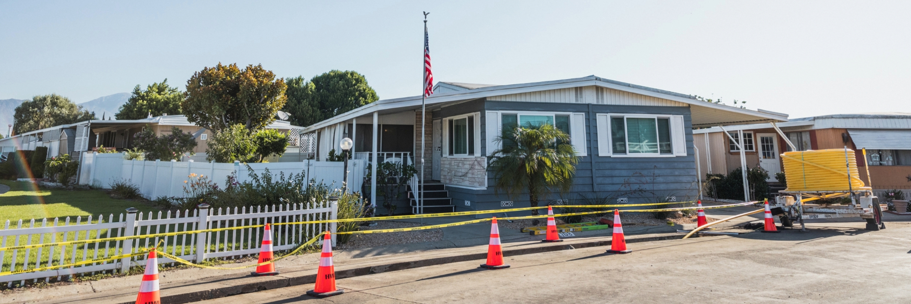 Mobile home with construction going on in front of the home.