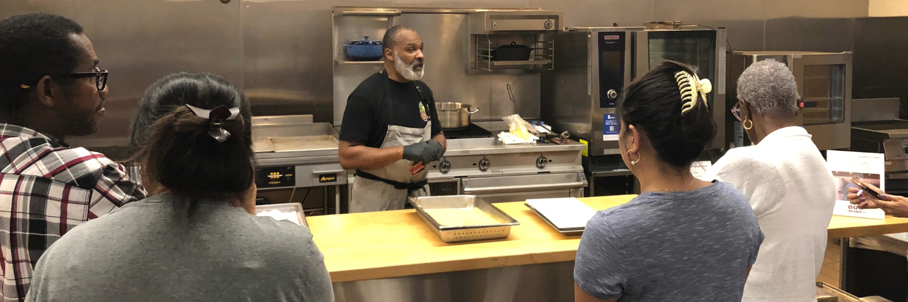 Man doing a cooking demonstration in front of people