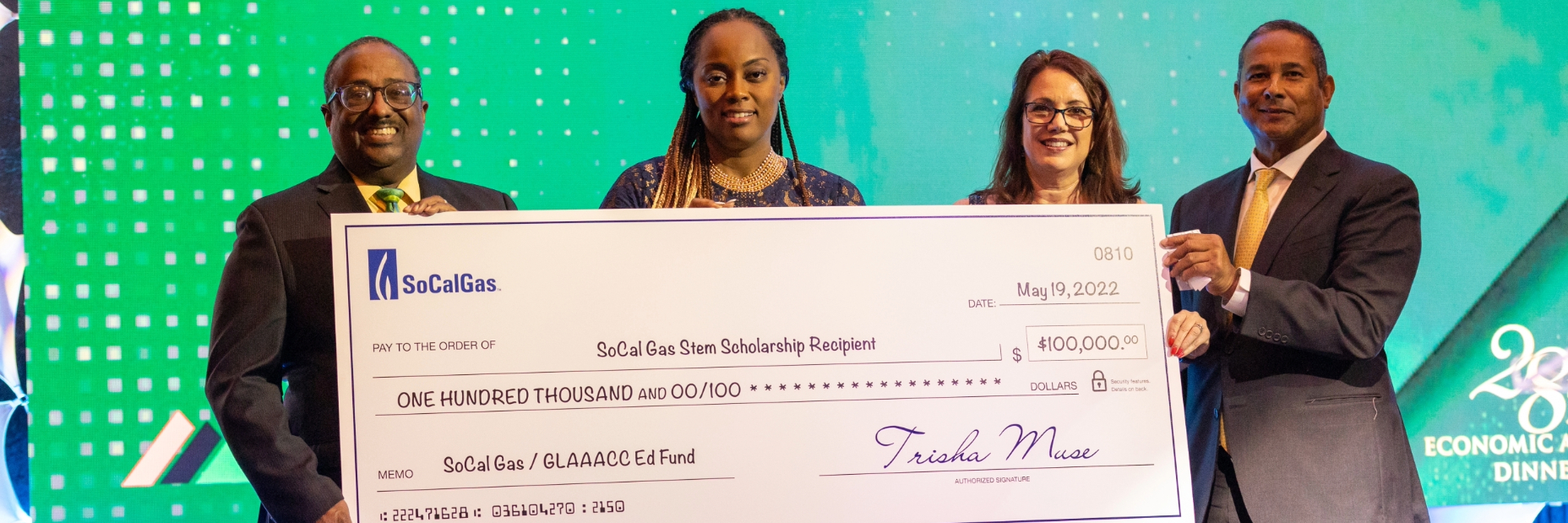 SoCalGas and GLAAACC on stage holding a giant check