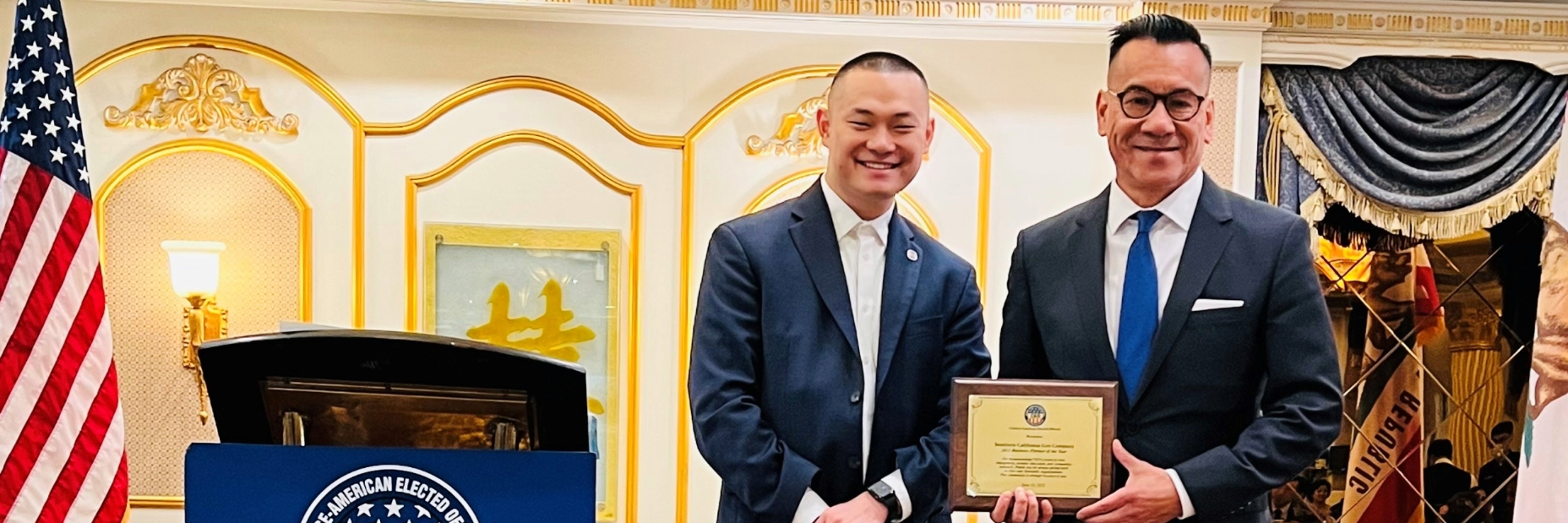 Two men holding the award