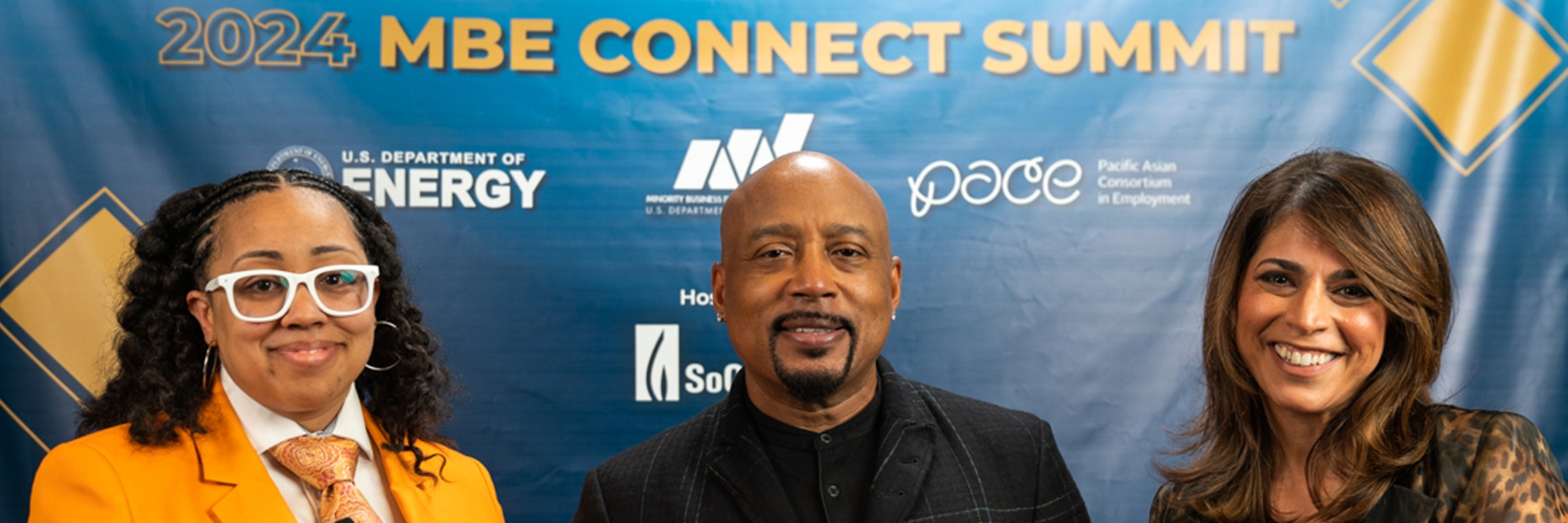 Maryam Brown, Daymond John and DOE representative pose for picture.