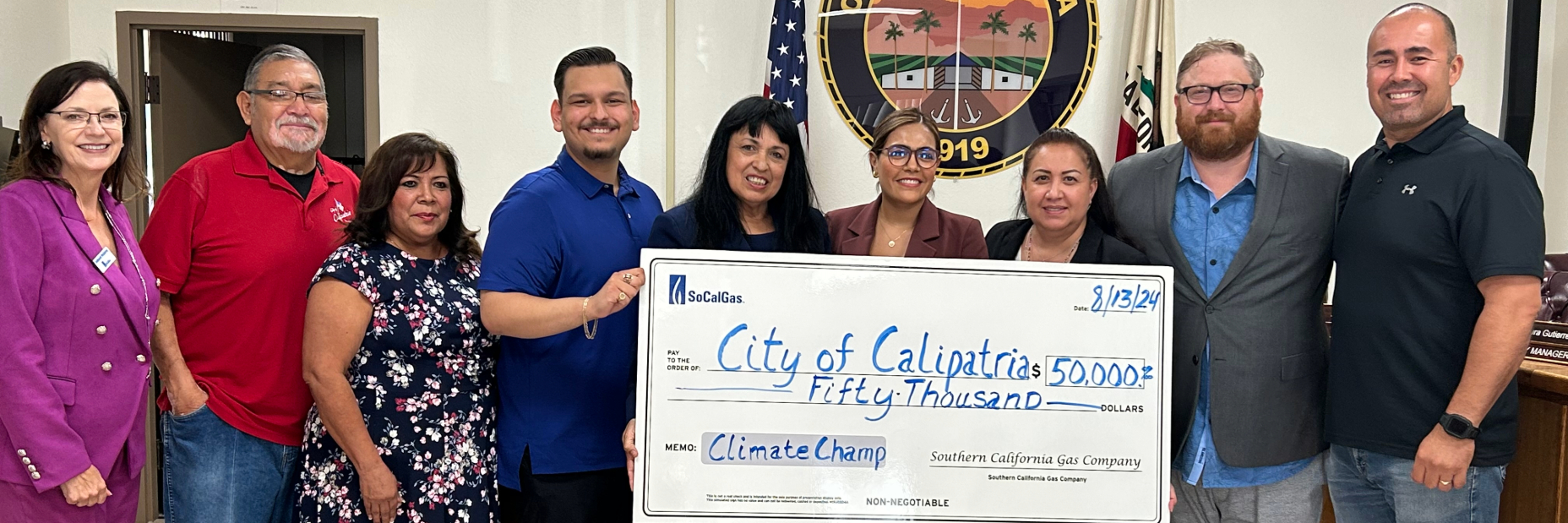 People holding a large check for a climate resiliency grant