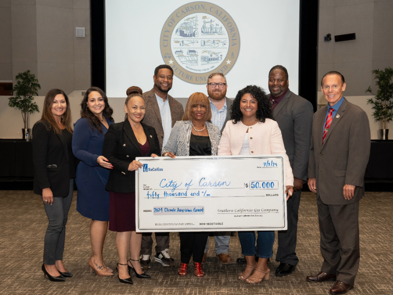 A group of people holding a check