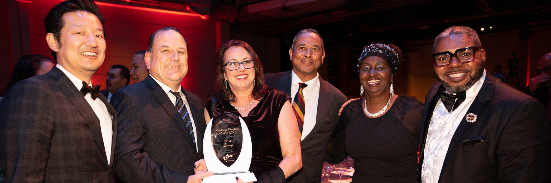 Scott holding award with group of people