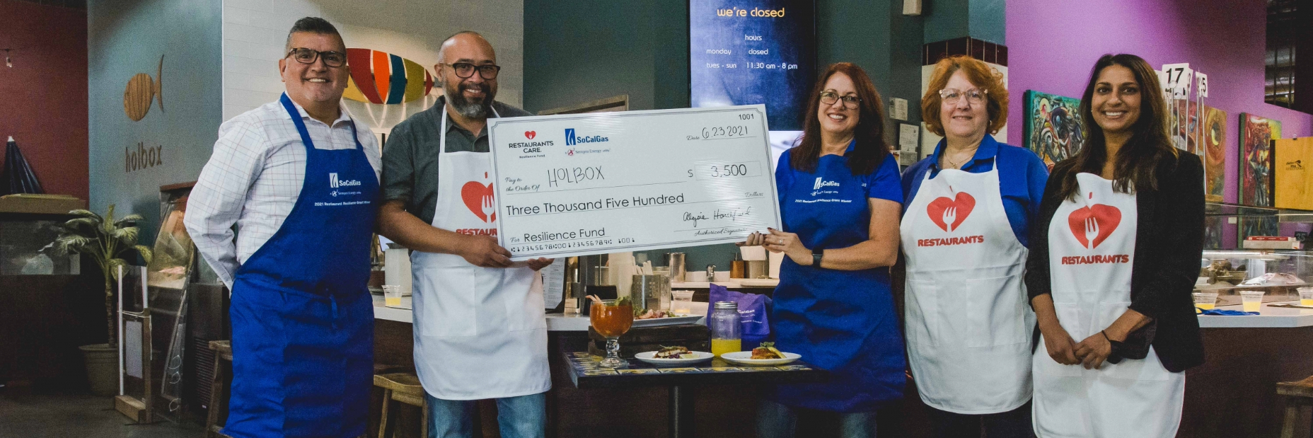 People holding a giant check posing for a photo