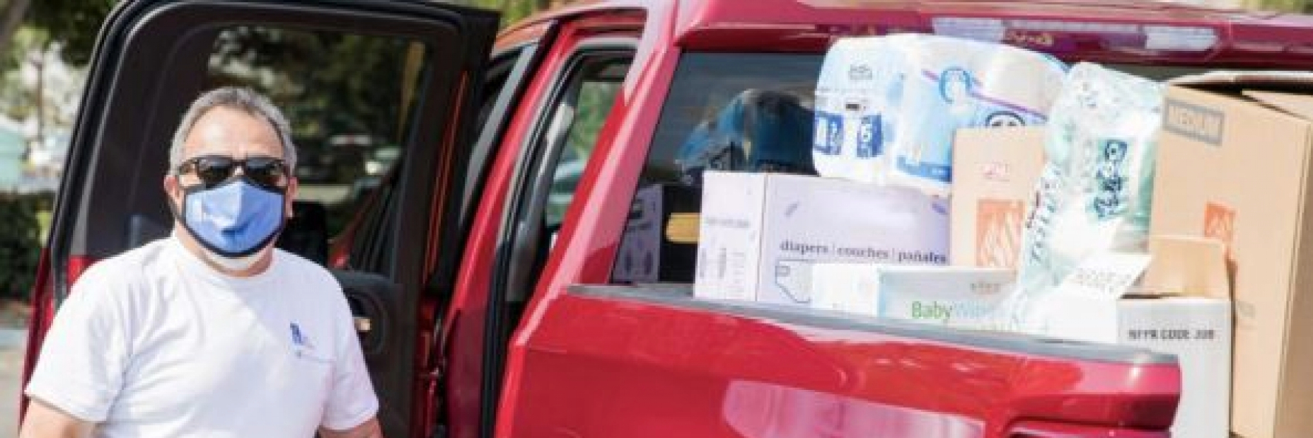 Man unloading paper towels from a ford f-150