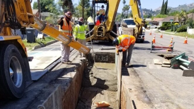 workers pouring concrete into trench
