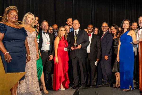 Scott Drury accepting award with a group of people