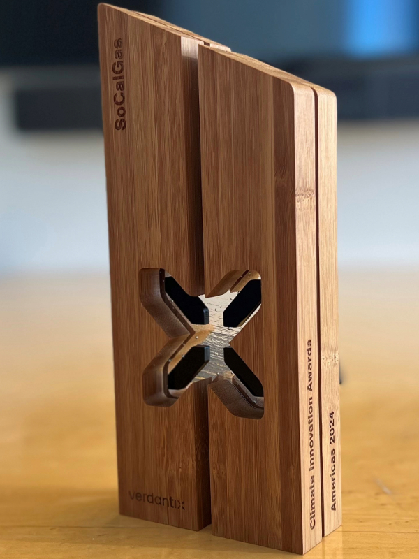 Image of the wooden Climate Innovation Award standing on a desk