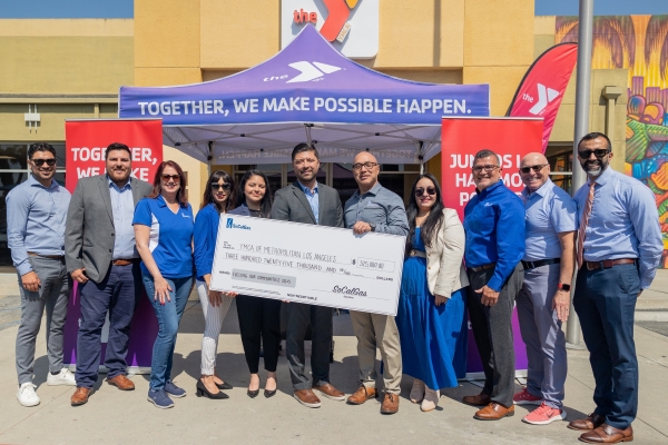 A group of people holding a giant check