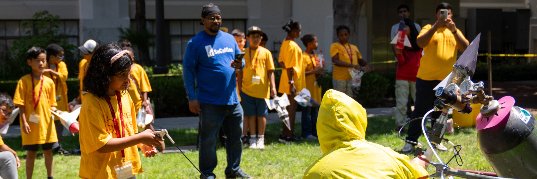 Students shooting off @ liter bottles shaped like rockets at the quad on the campus of USC.