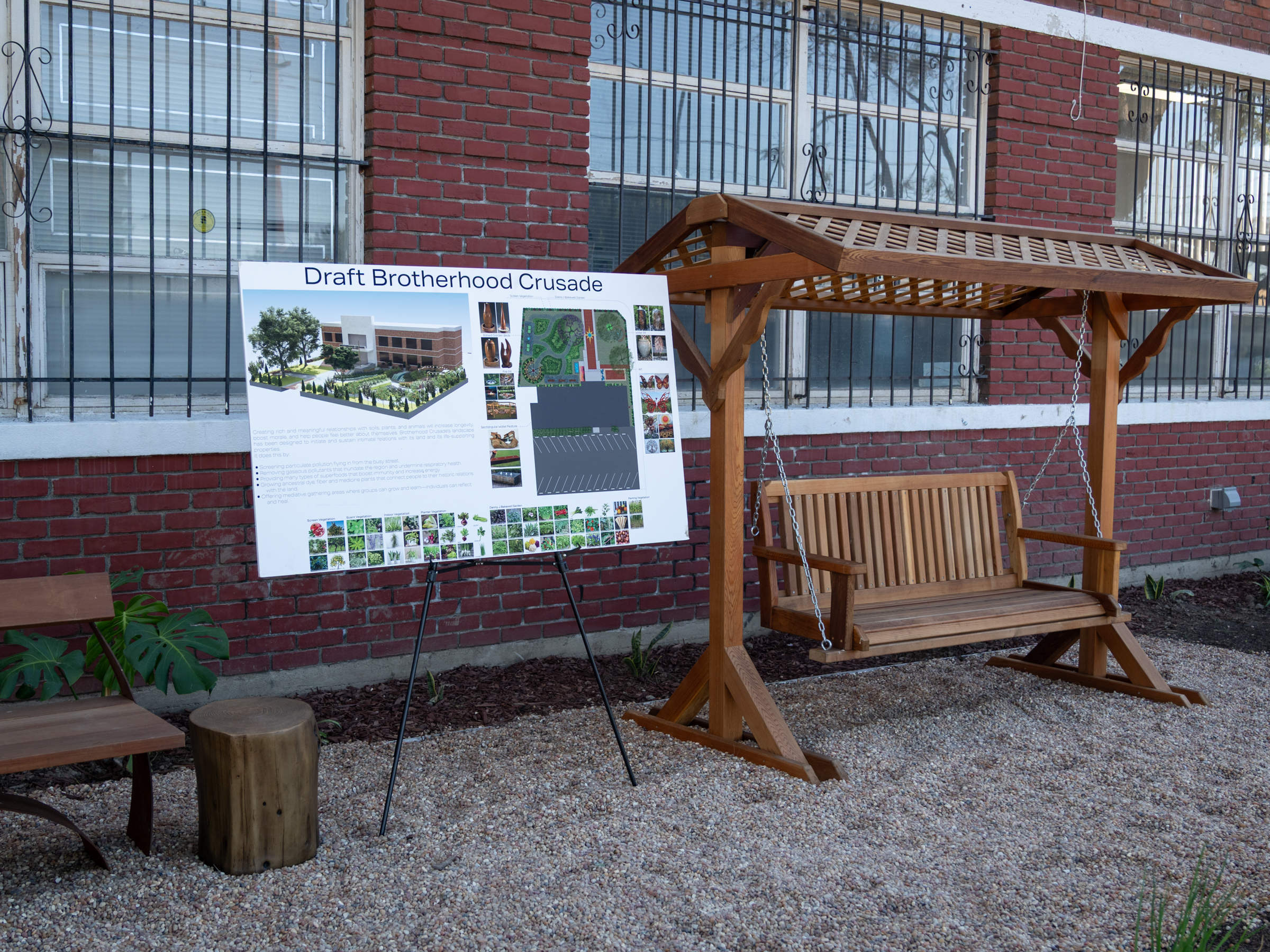 Sign next to swing bench in garden