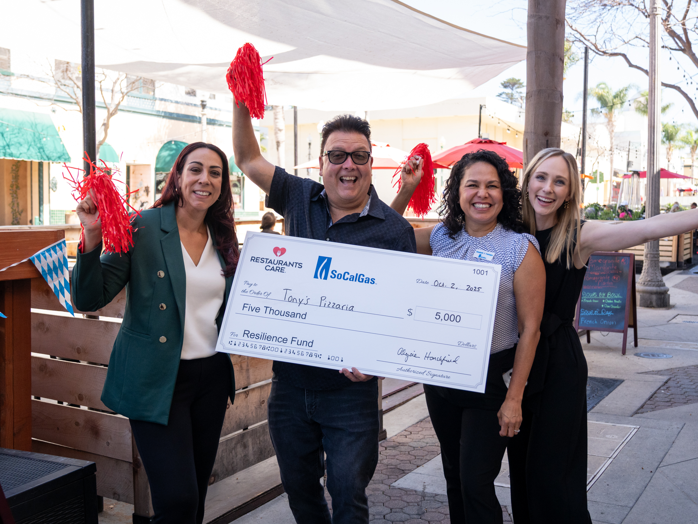 People holding large check