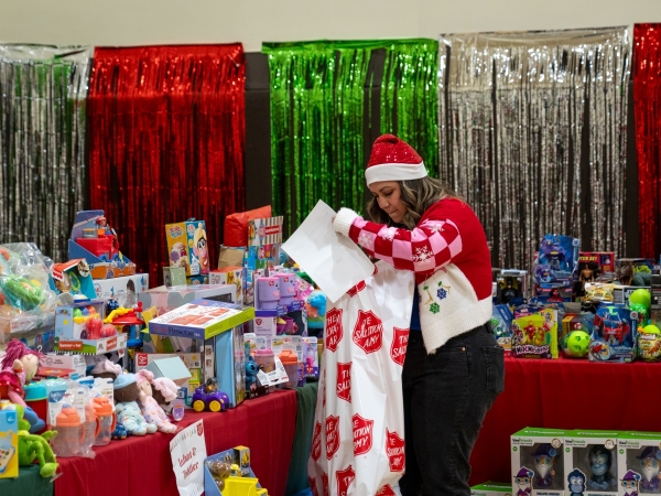 SoCalGas Employee helping add items to bag at Pasadena toy drive