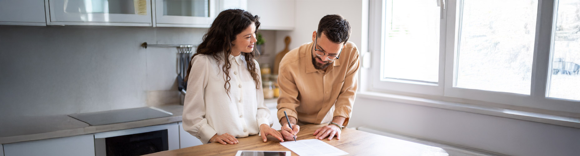Man and woman smiling in kitchen