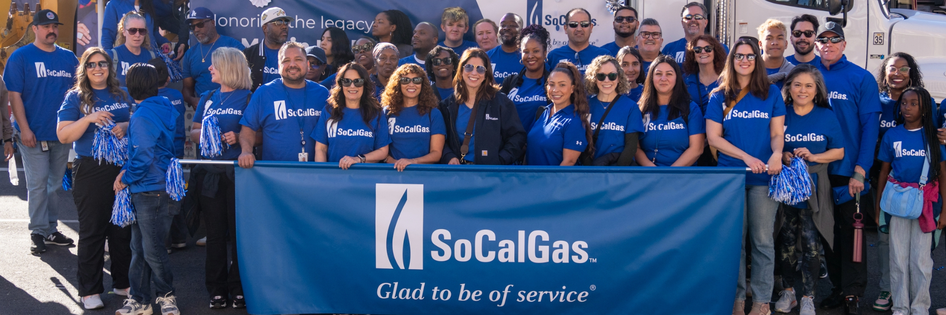 SoCalGas employees standing in front of socalgas banner at MLK Day parade
