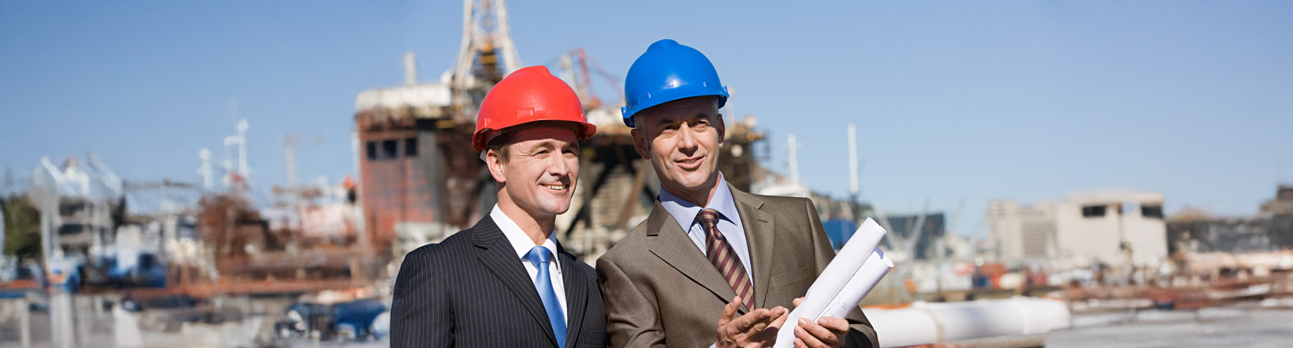 men in hardhats with blueprints