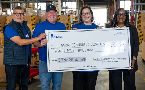 socalgas executives hold check to food bank
