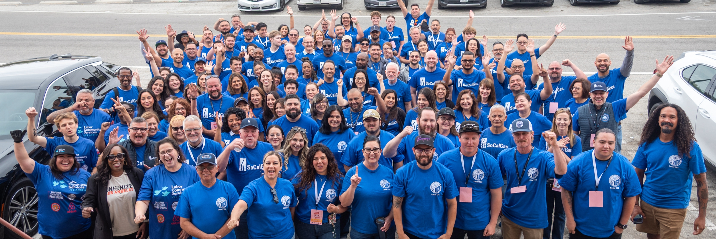 Dozens of socalgas employees posing for a photo at a food sorting facility.