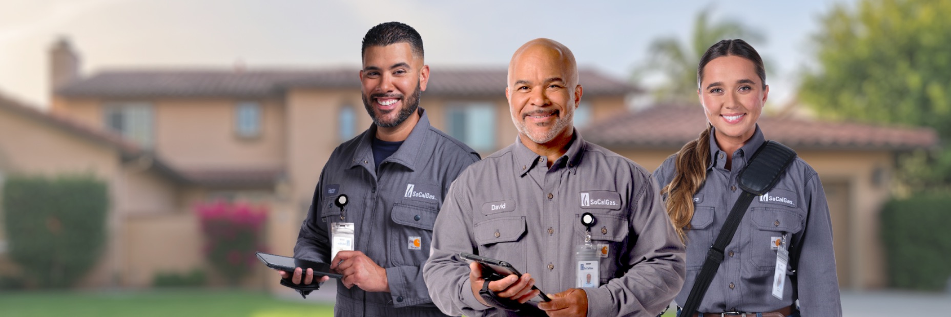 three employees wearing new uniforms
