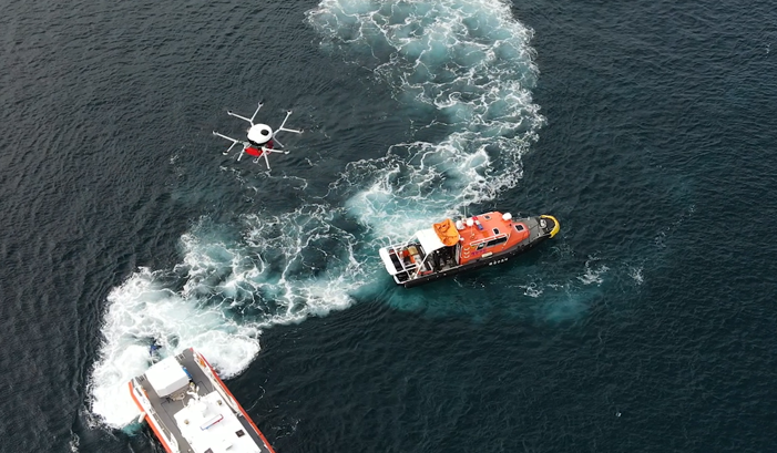 Photo of hydrogen fuel cell drone over a body of water and two ships.