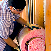 image of man installing attic insulation