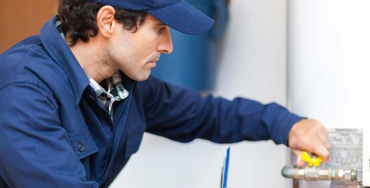 technician servicing water heater