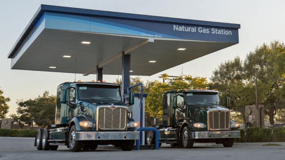 two trucks filling up at a CNG station