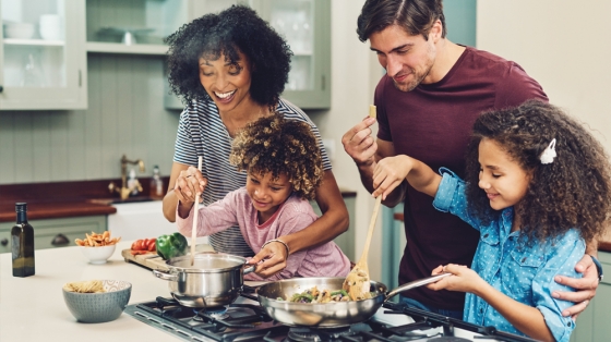 Family Cooking Together using a gas stovetop