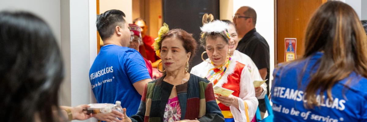 people attending celebration for lunar new year arriving into the room
