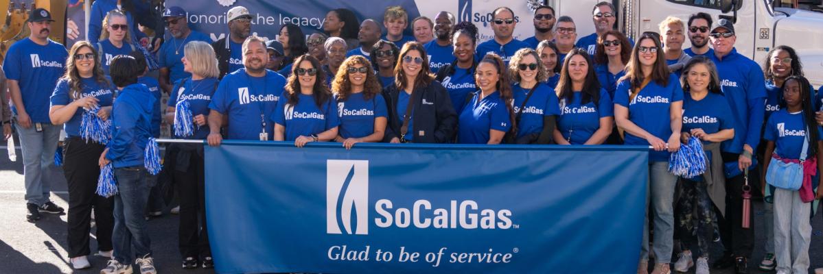 SoCalGas employees standing in front of socalgas banner at MLK Day parade