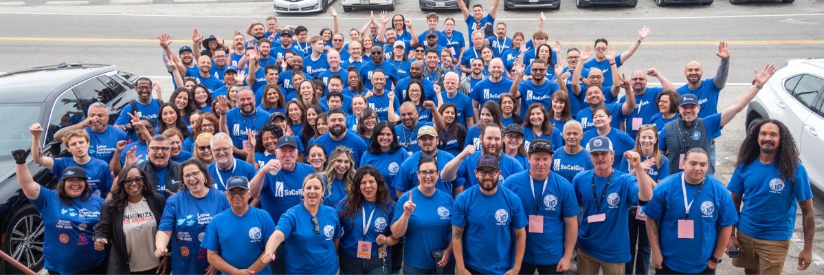 Dozens of socalgas employees posing for a photo at a food sorting facility.
