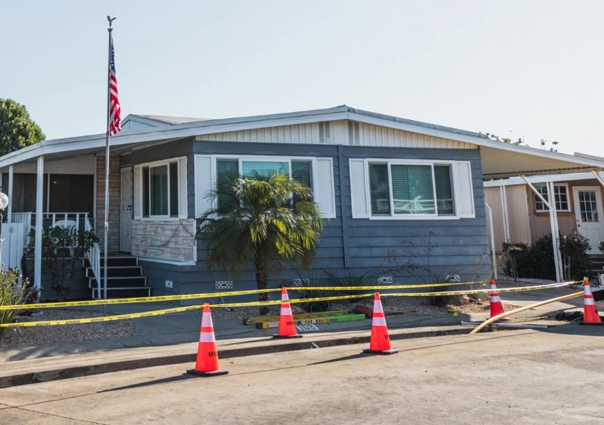 Mobile home with construction going on in front of the home.