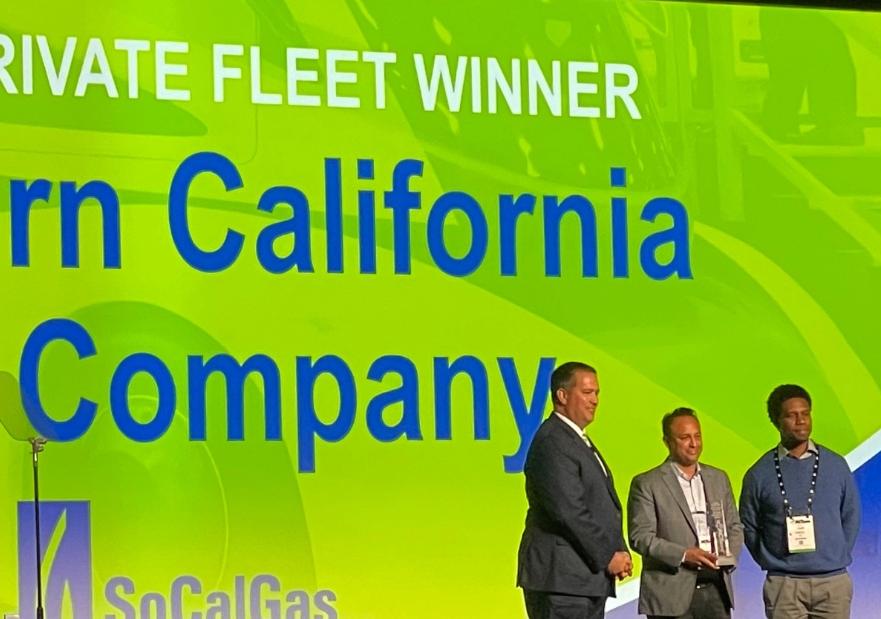 Socalgas executives accepting the award on stage