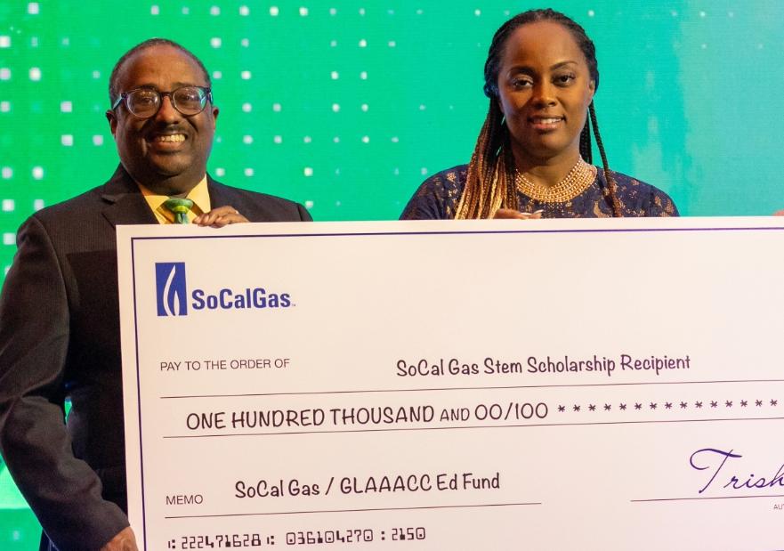 SoCalGas and GLAAACC on stage holding a giant check