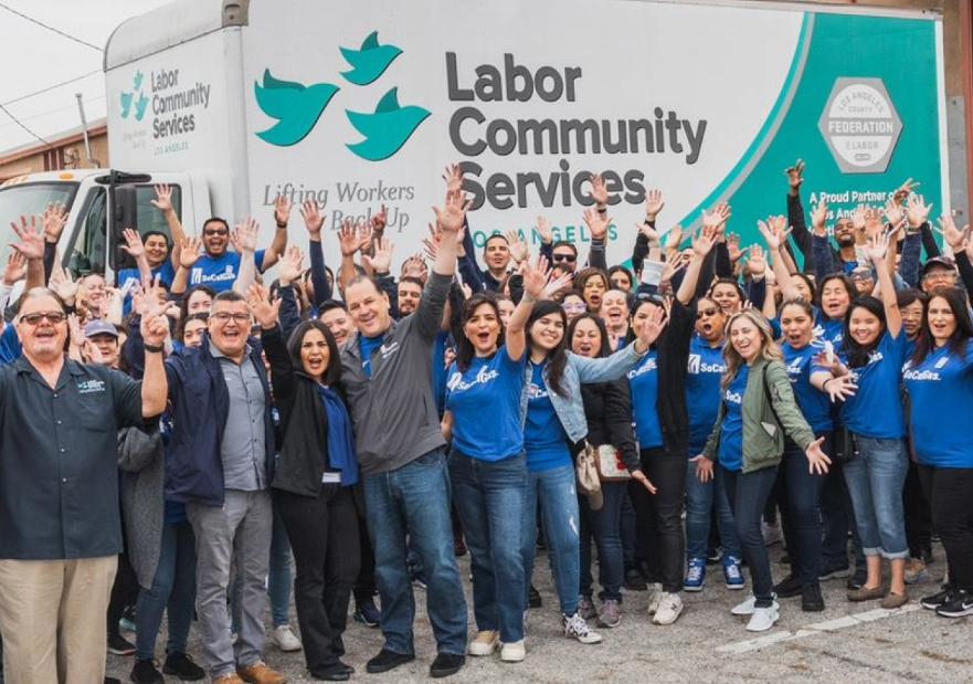 socalgas volunteers posing in front of labor community services truck at stamp out hunger event