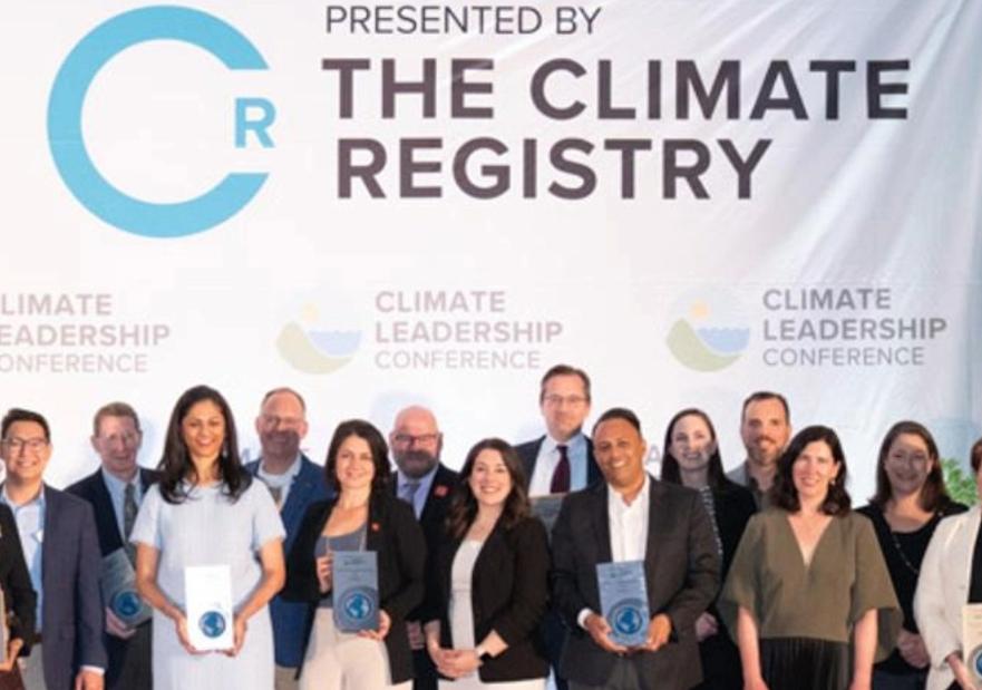 Award Winners on stage holding their awards at the Climate Registry Event