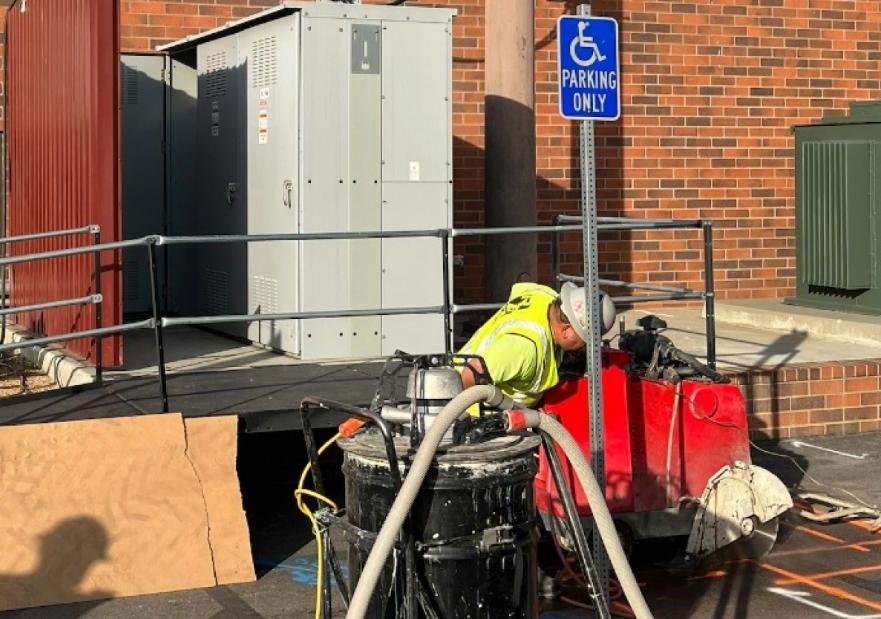 Workers moving in an electric vehicle charger