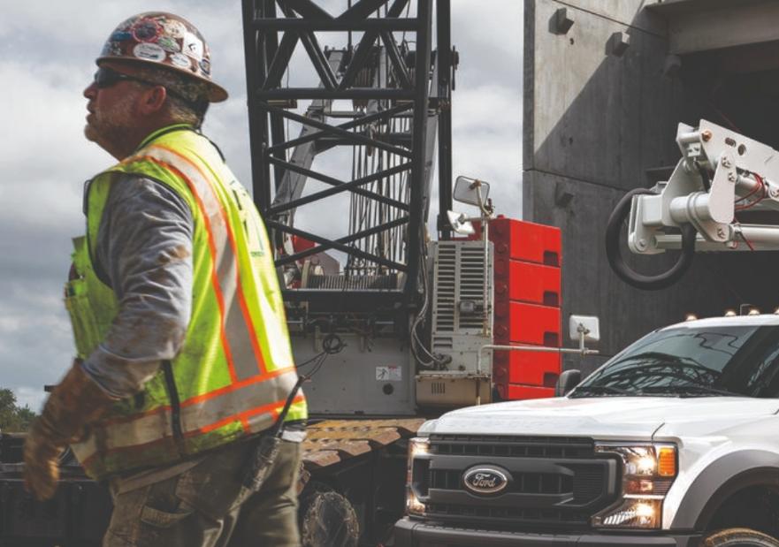 Man standing in front of ford 550 on a work site