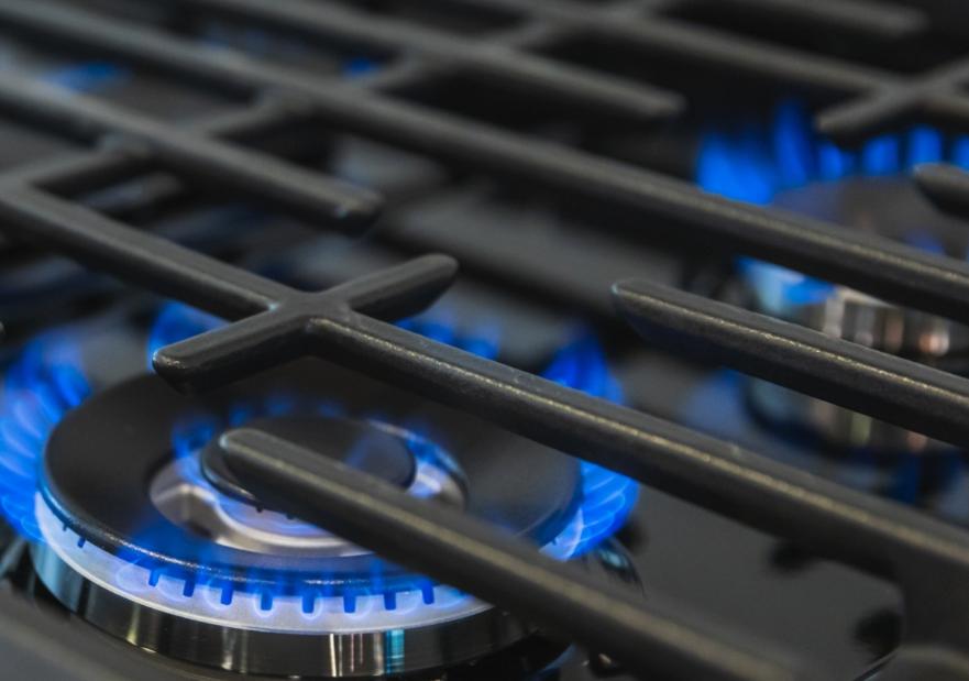 Blue flame burning on a stove top