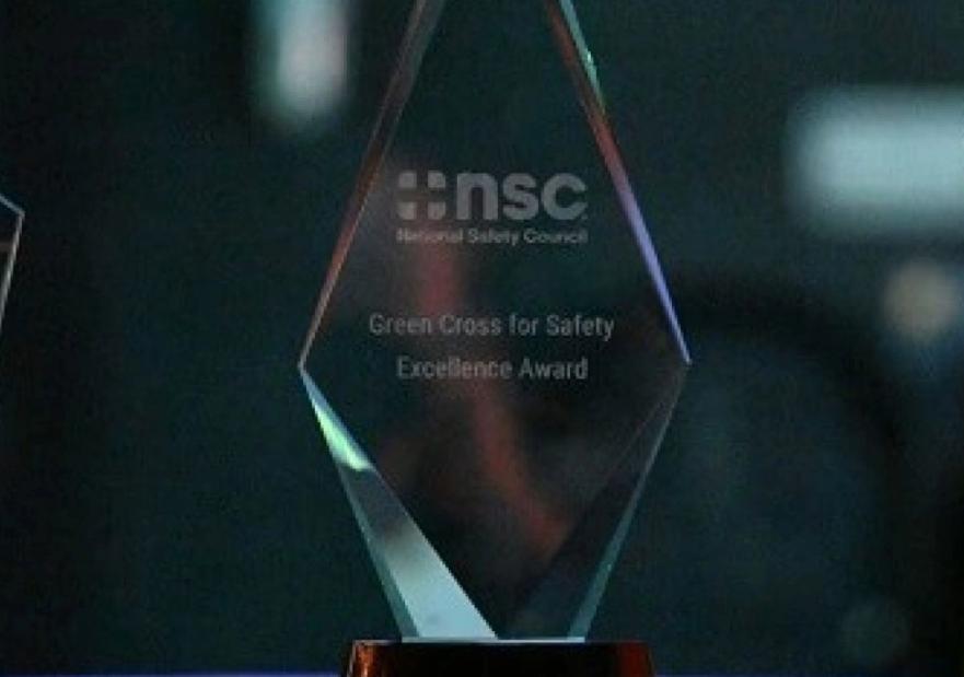 Image of three green cross awards on a table