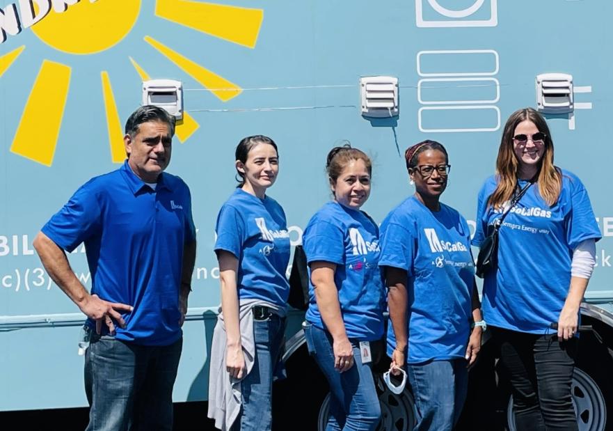 volunteers standing in front of a mobile laundry truck