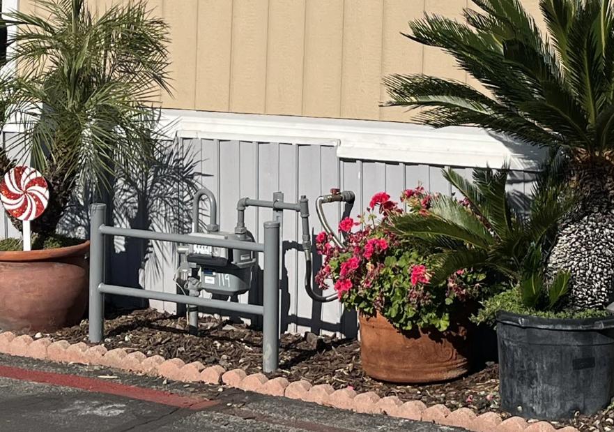 Image of a gas meter against the wall of a mobile home