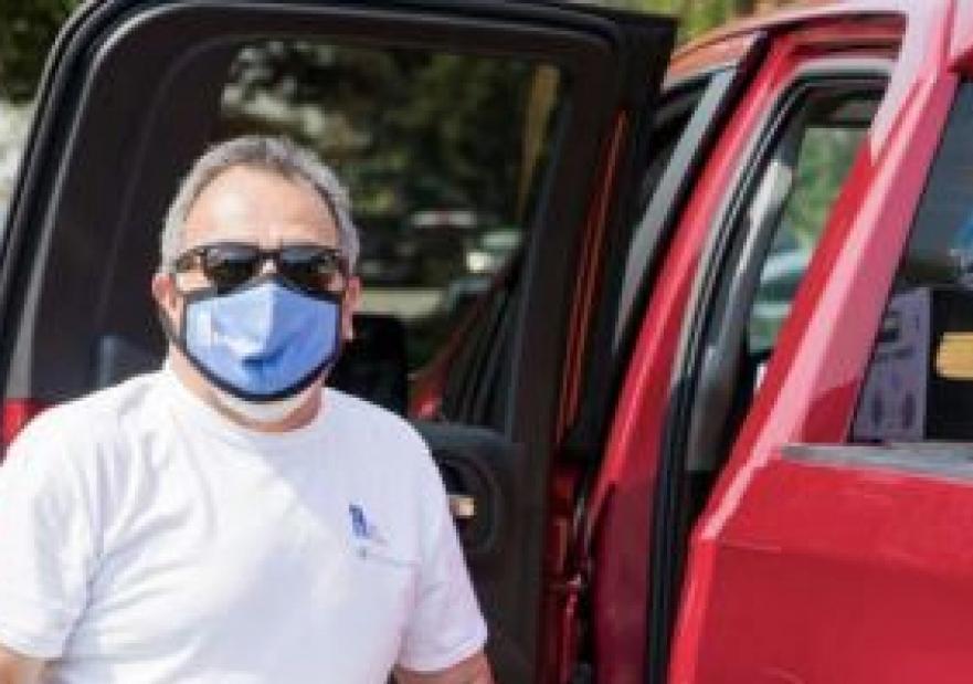 Man unloading paper towels from a ford f-150
