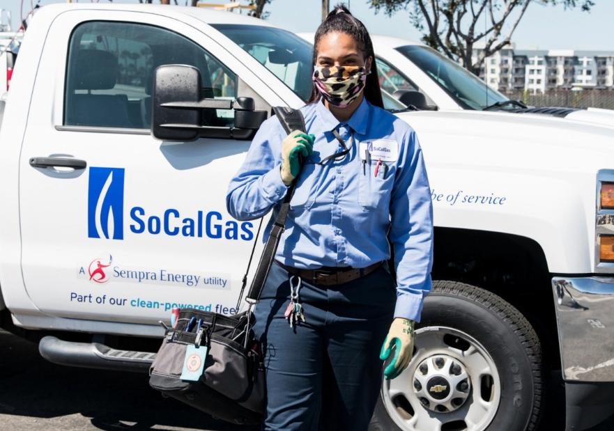 Female worker walking in front of socalgas service truck