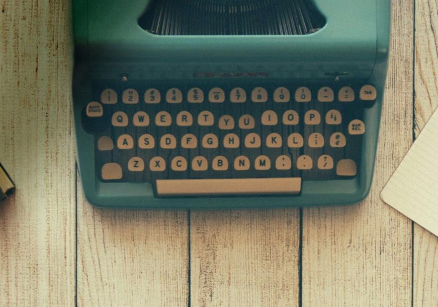 Generic Image with a typewriter and a notebook on a table
