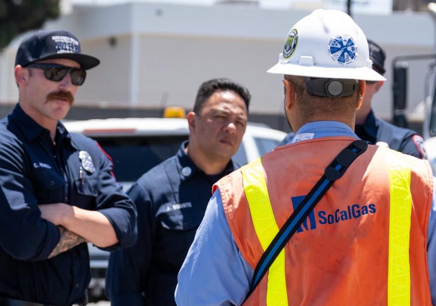 SoCalGas employee walking firefighters through an exercise about responding to the scene